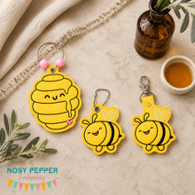 Load image into Gallery viewer, Happy Bee snap tabs, eyelet fobs, and bagtag set machine embroidery file (single and multi files included)--2026 Skill Builder Bundle--DIGITAL DOWNLOAD