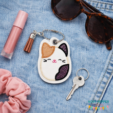 Load image into Gallery viewer, Calico Squishy snap tab and eyelet fob machine embroidery file (single and multi files included) DIGITAL DOWNLOAD