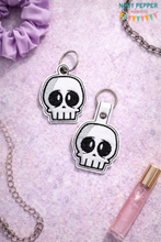 Load image into Gallery viewer, Nervous Skull snap tab and eyelet fob May 2024 Mystery Bundle machine embroidery file (single and multi files included)