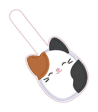 Load image into Gallery viewer, Calico Squishy snap tab and eyelet fob machine embroidery file (single and multi files included) DIGITAL DOWNLOAD