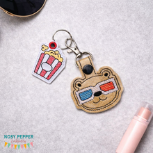 Load image into Gallery viewer, Movie Bear Snap tab and Charm set 4x4 machine embroidery design DIGITAL DOWNLOAD