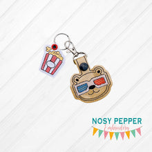 Load image into Gallery viewer, Movie Bear Snap tab and Charm set 4x4 machine embroidery design DIGITAL DOWNLOADMovie Bear Snap tab and Charm set 4x4 machine embroidery design DIGITAL DOWNLOAD